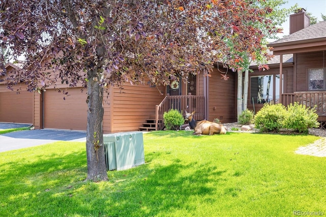 exterior space with a garage and a front lawn