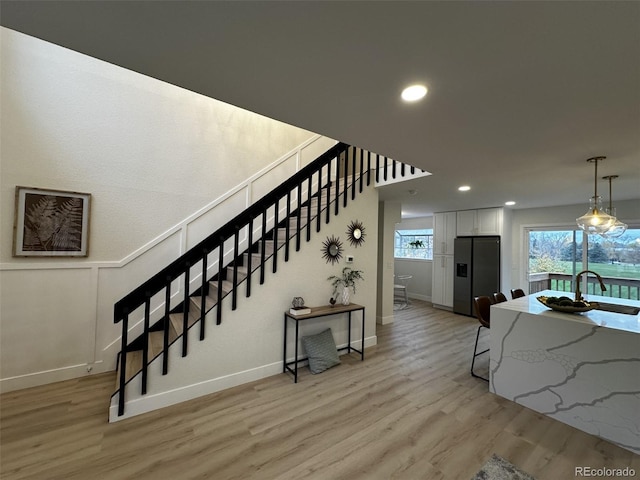 stairway with sink and wood-type flooring