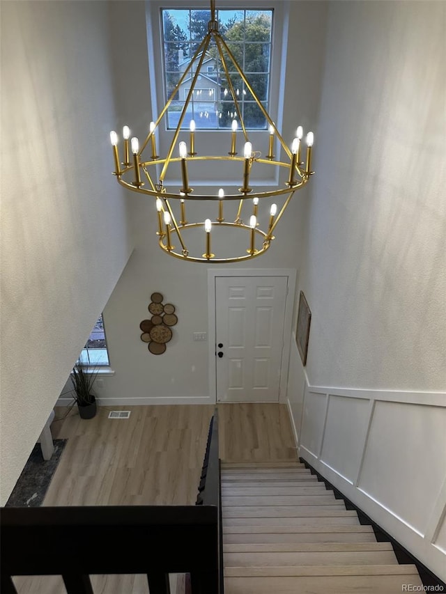 staircase featuring hardwood / wood-style floors and plenty of natural light