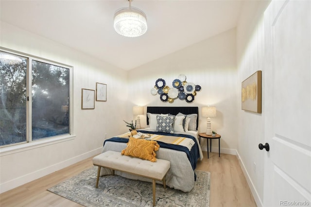 bedroom with lofted ceiling and hardwood / wood-style floors