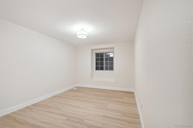 empty room with light hardwood / wood-style floors