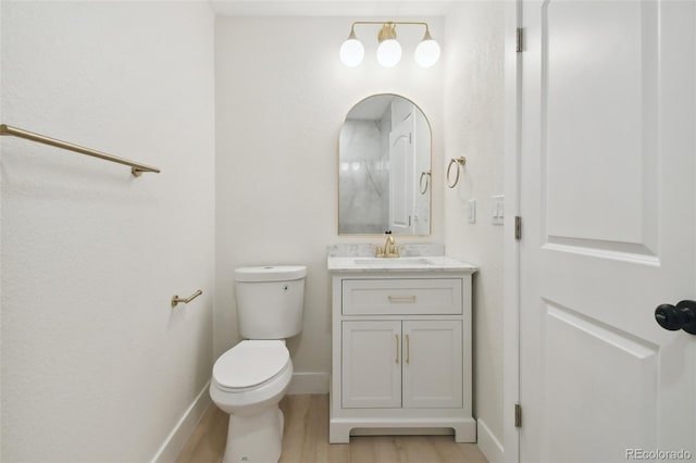 bathroom with vanity, hardwood / wood-style floors, and toilet