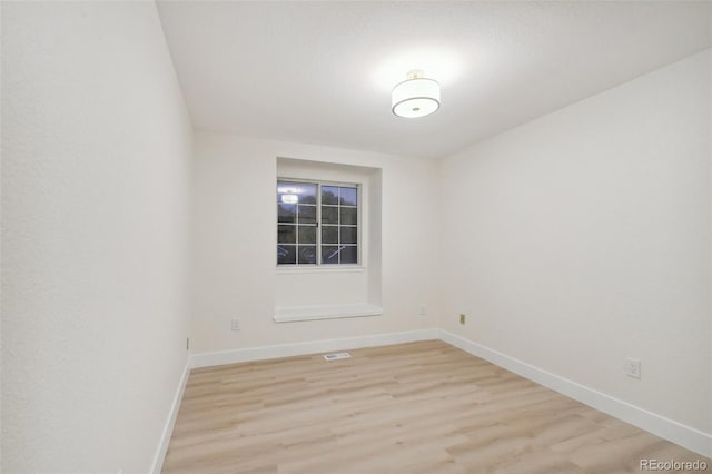 spare room with light hardwood / wood-style floors