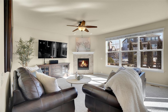 carpeted living room featuring visible vents, a fireplace, a ceiling fan, and baseboards