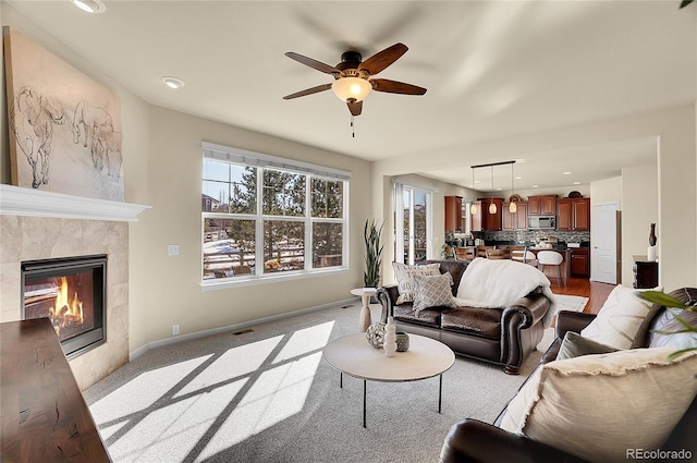 living room with visible vents, baseboards, recessed lighting, a fireplace, and a ceiling fan