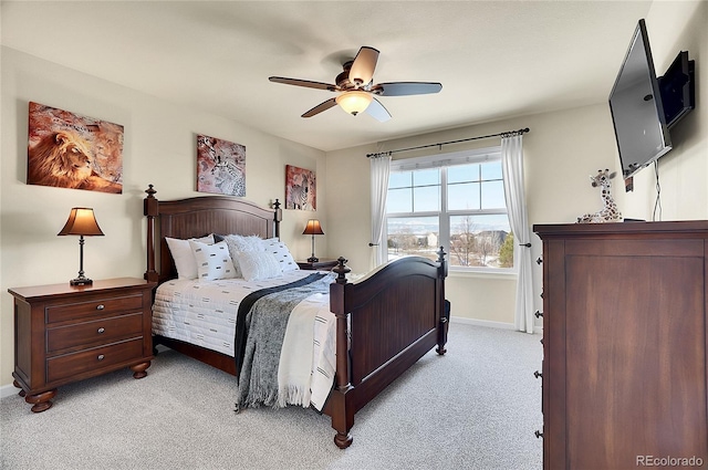 bedroom with baseboards, light colored carpet, and a ceiling fan