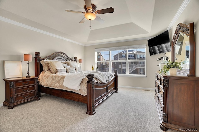 bedroom with baseboards, ceiling fan, ornamental molding, a raised ceiling, and light colored carpet