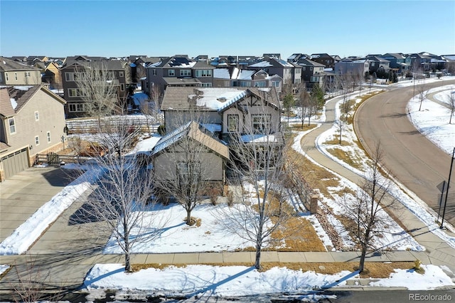 snowy aerial view featuring a residential view