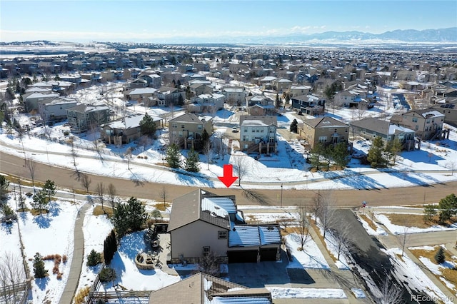 snowy aerial view featuring a residential view