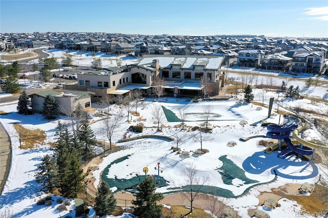 snowy aerial view with a residential view