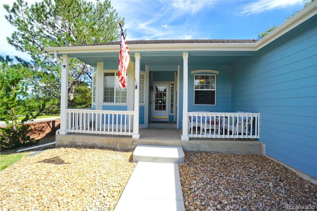 view of exterior entry with covered porch