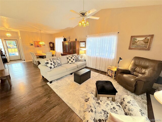 living room featuring lofted ceiling, dark wood-type flooring, and ceiling fan