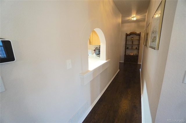 corridor featuring dark hardwood / wood-style flooring