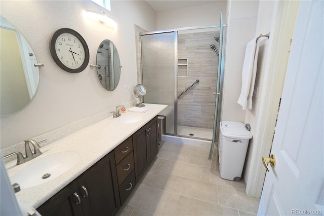 bathroom with tile patterned floors, an enclosed shower, and vanity