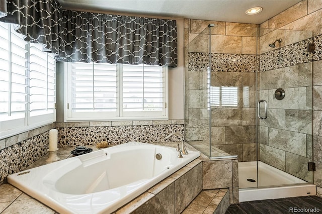 full bath featuring a shower stall and a garden tub