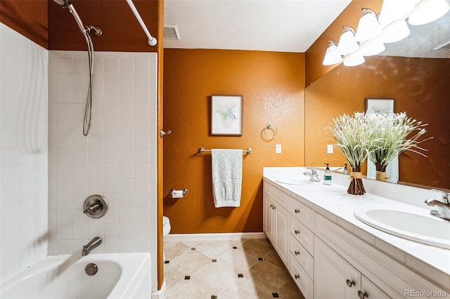 bathroom featuring double vanity, visible vents, tub / shower combination, and a sink