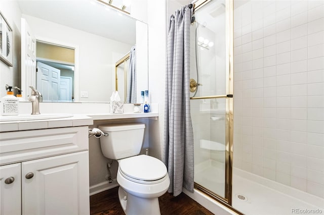 full bath with a stall shower, toilet, vanity, and wood finished floors