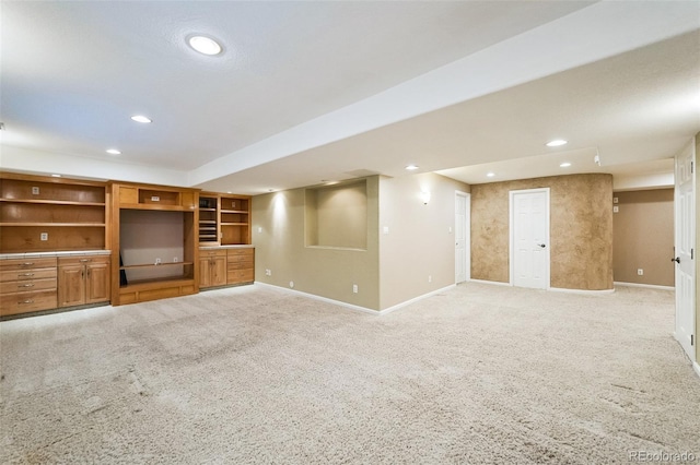 unfurnished living room featuring recessed lighting, light colored carpet, and baseboards