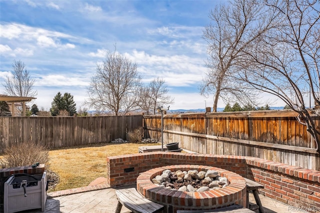 view of patio / terrace with a fire pit and a fenced backyard