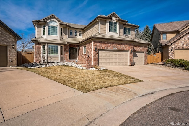 view of front of house featuring brick siding, an attached garage, fence, driveway, and a gate