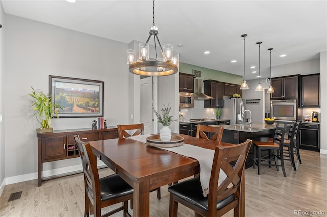 17358 W 95th Ave, Arvada, CO 80007 - dining room with light wood-style flooring, a chandelier, and recessed lighting