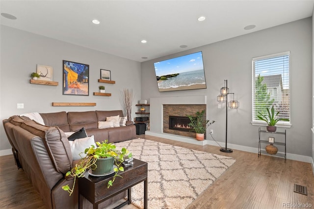 17358 W 95th Ave, Arvada, CO 80007 - living area featuring wood finished floors, a lit fireplace, and recessed lighting