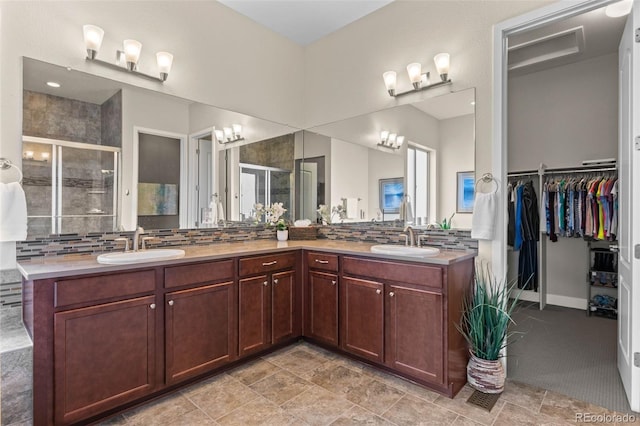 17358 W 95th Ave, Arvada, CO 80007 - full bathroom featuring a stall shower, backsplash, and double vanity