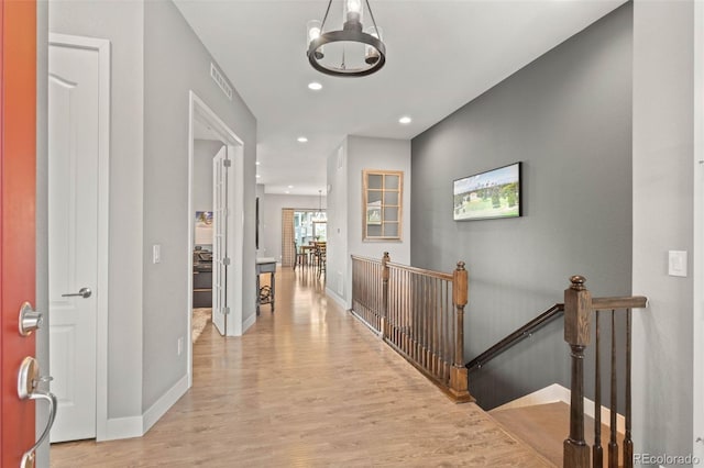 17358 W 95th Ave, Arvada, CO 80007 - hallway featuring an upstairs landing, wood finished floors, a chandelier, and recessed lighting