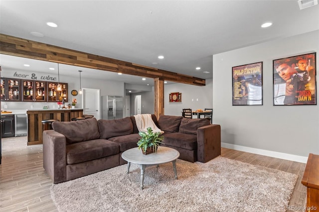 17358 W 95th Ave, Arvada, CO 80007 - living room with wet bar, recessed lighting, light wood finished floors, and beamed ceiling