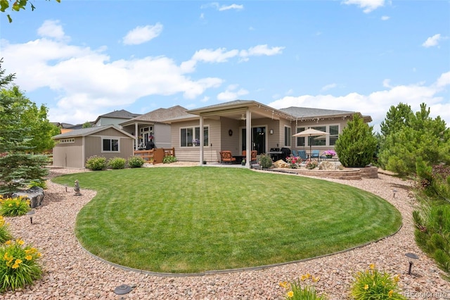 17358 W 95th Ave, Arvada, CO 80007 - rear view of house featuring a yard, a patio, and an outbuilding