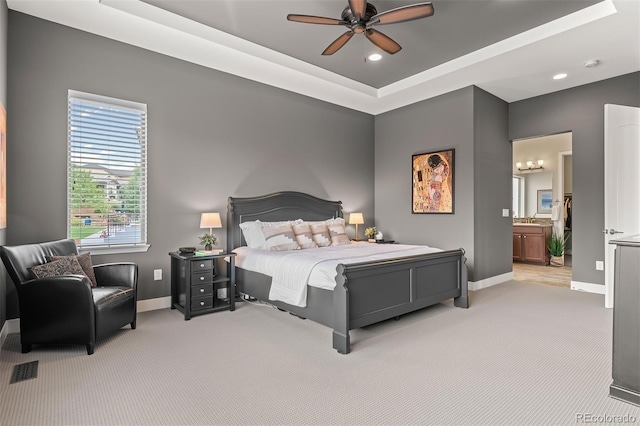 17358 W 95th Ave, Arvada, CO 80007 - bedroom featuring light colored carpet, a tray ceiling, recessed lighting, ensuite bathroom, and a ceiling fan