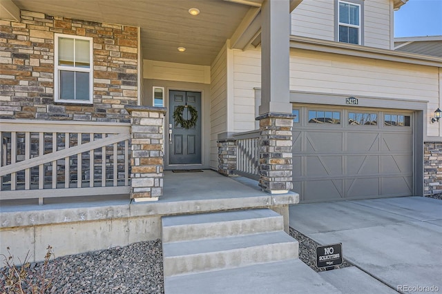 property entrance with driveway, stone siding, a garage, and a porch