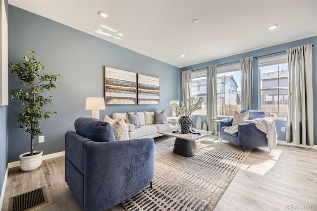 living room featuring recessed lighting, wood finished floors, visible vents, and baseboards