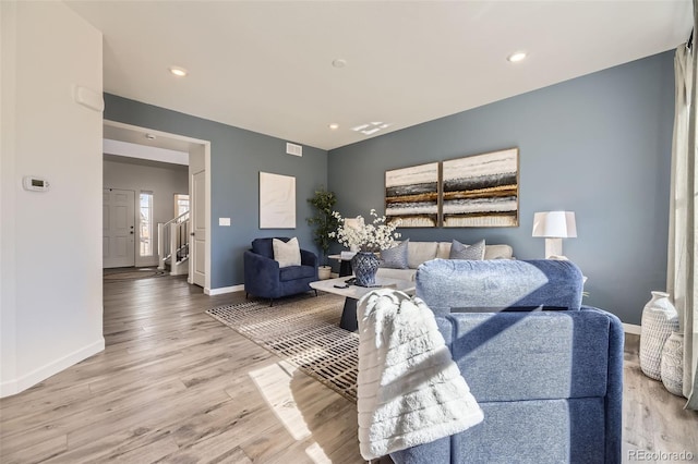 living room with recessed lighting, wood finished floors, visible vents, and baseboards