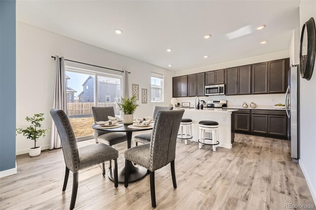 dining room featuring recessed lighting, light wood-style flooring, and baseboards