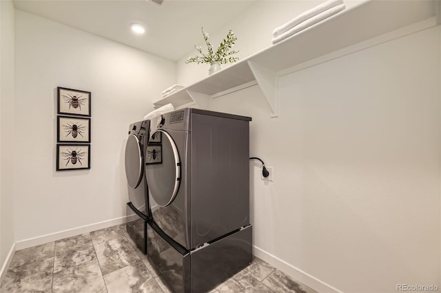 washroom featuring laundry area, independent washer and dryer, and baseboards