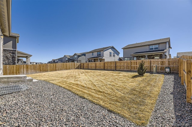 view of yard with a residential view and a fenced backyard