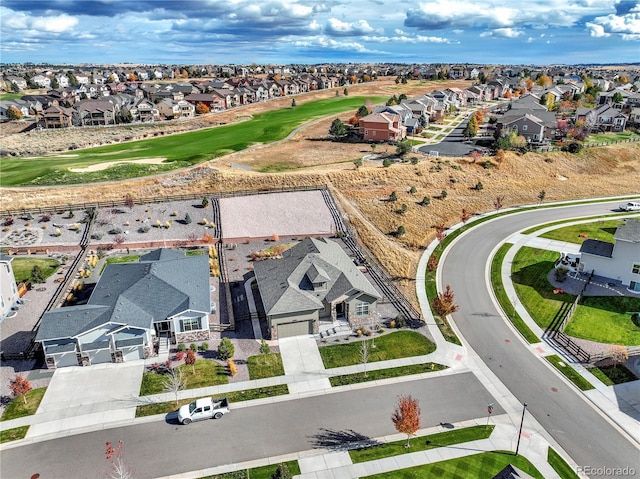 drone / aerial view featuring golf course view and a residential view