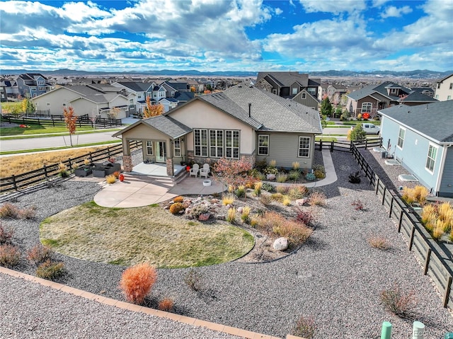 back of property with roof with shingles, a patio, a residential view, and fence private yard