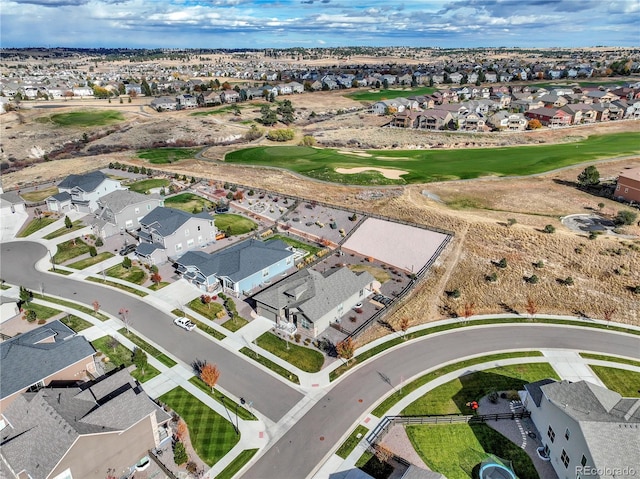aerial view with golf course view and a residential view