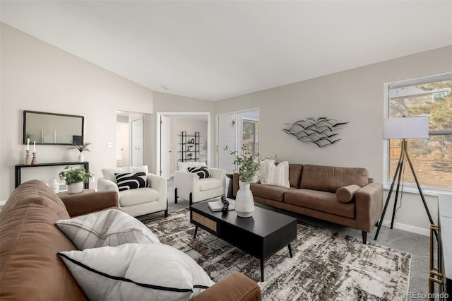 living room with lofted ceiling and carpet flooring