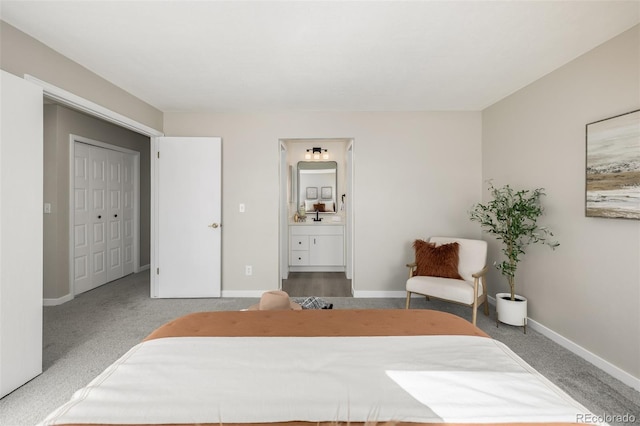 carpeted bedroom featuring connected bathroom