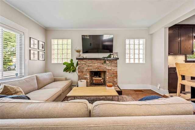 living room with ornamental molding, a wealth of natural light, and wood finished floors