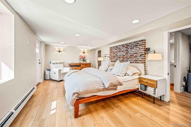 bedroom with a baseboard heating unit, recessed lighting, and light wood-style floors