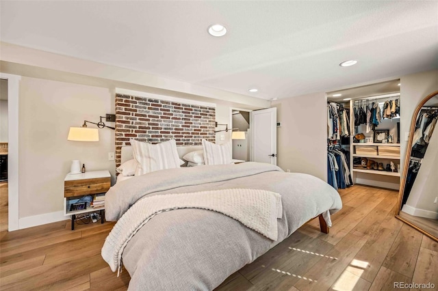 bedroom with baseboards, a closet, and light wood-style floors