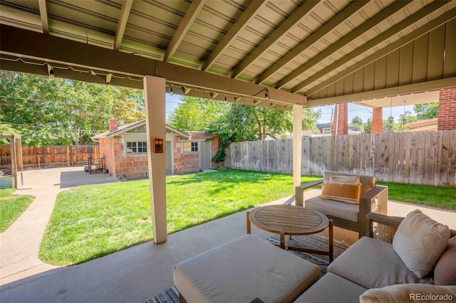 view of patio with an outbuilding and a fenced backyard