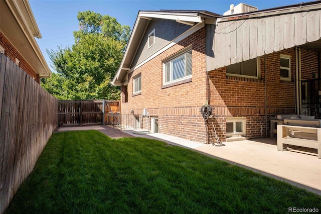 rear view of property featuring a yard and a patio