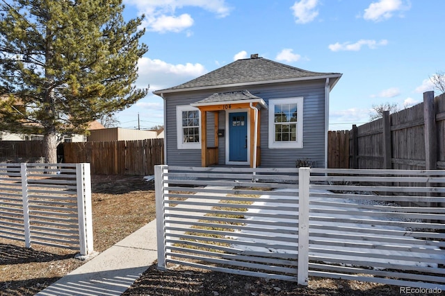 104 Stuart St, Denver, CO 80219 - shotgun-style home with a fenced backyard and roof with shingles