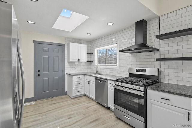 104 Stuart St, Denver, CO 80219 - kitchen featuring stainless steel appliances, open shelves, wall chimney range hood, a skylight, and a sink