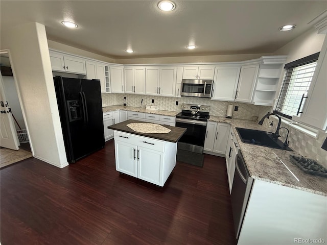 8318 Ivory Loop, Peyton, CO 80831 - kitchen with stainless steel appliances, a sink, open shelves, decorative backsplash, and dark wood finished floors